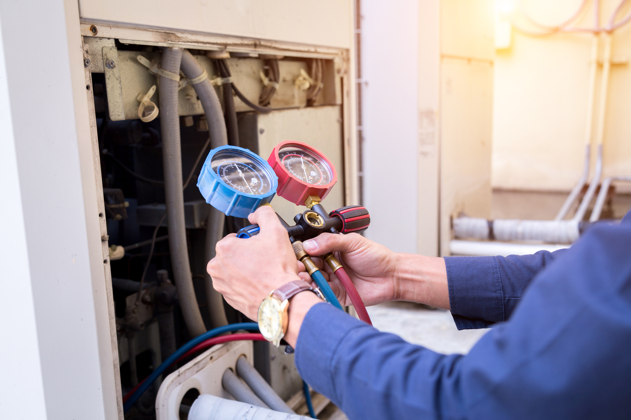 Tech Using Tool To Service AC Unit