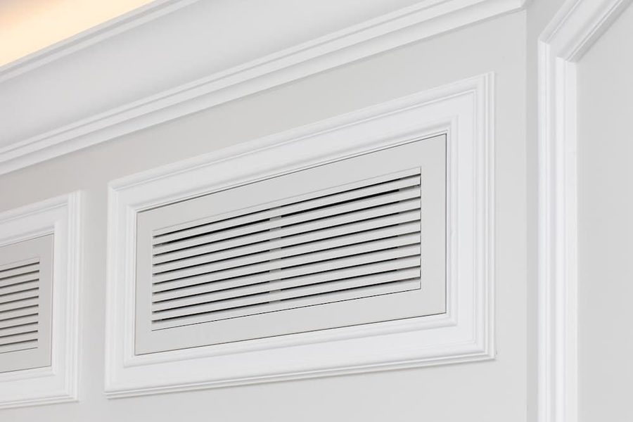 A vent on the wall of a home where airflow circulates.